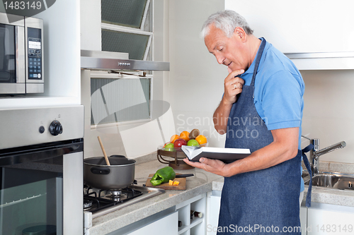 Image of Senior Man Holding Recipe Book