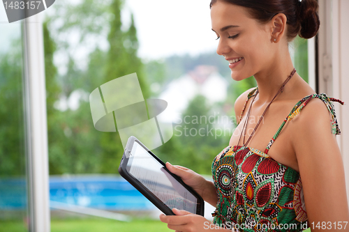 Image of Woman looking at tablet pc