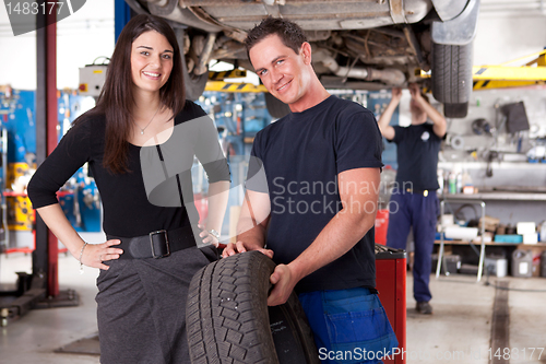 Image of Customer with Mechanic and Tire