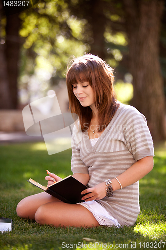 Image of Student with Journal in Park