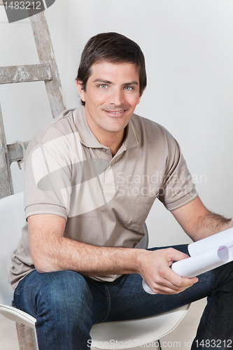 Image of Man holding with blueprint