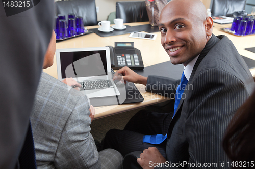 Image of Business people using laptop in office
