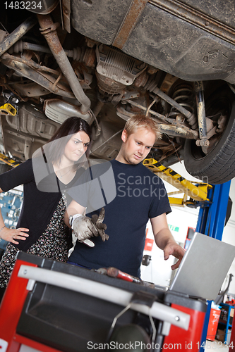 Image of Mechanic with Sceptical Customer