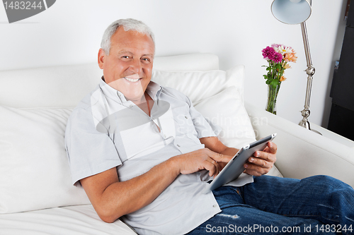 Image of Senior Man Using Digital Tablet PC