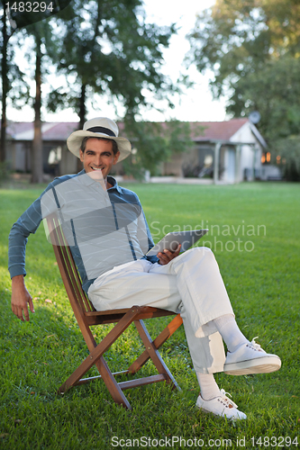 Image of Smiling Man Holding Tablet PC