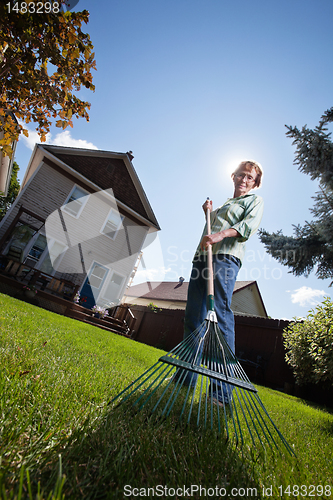 Image of Woman holding rake