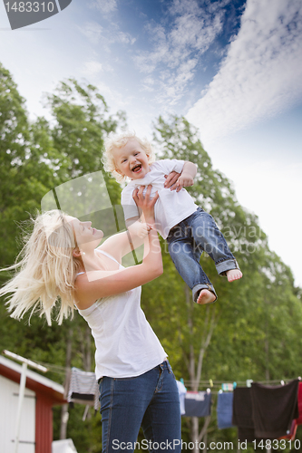 Image of Mother playing with baby