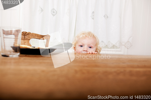 Image of Child Peeking Over Table