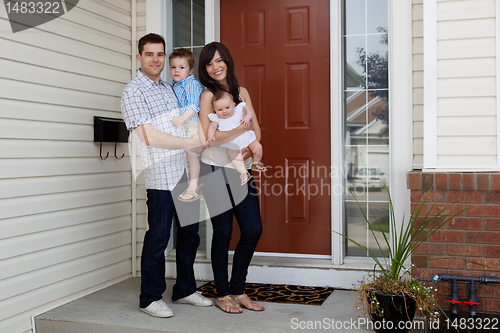 Image of Young Coupld Outside House with Kids