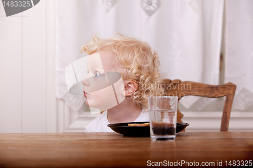 Image of Curious Young Boy at Table