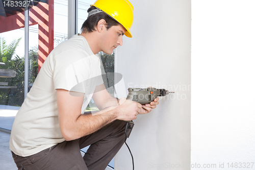 Image of Man with electronic drill machine