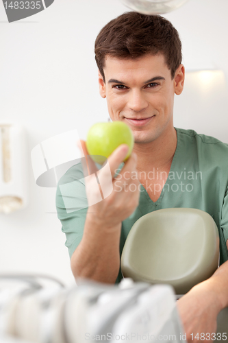 Image of Smiling Male Dentist with Apple