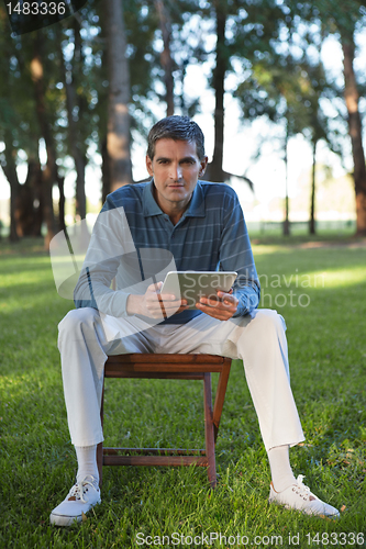 Image of Casual Man Holding Tablet PC