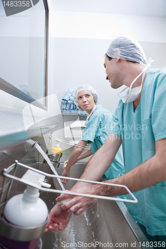 Image of Young surgeons washing hand