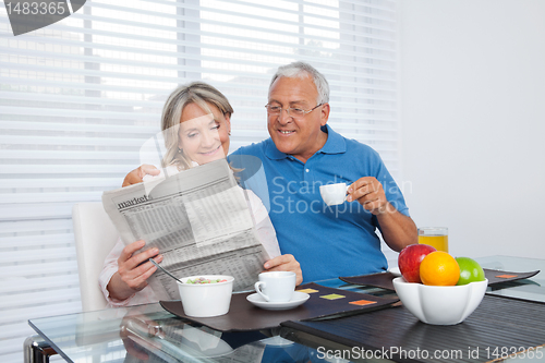 Image of Senior Couple Reading Newspaper