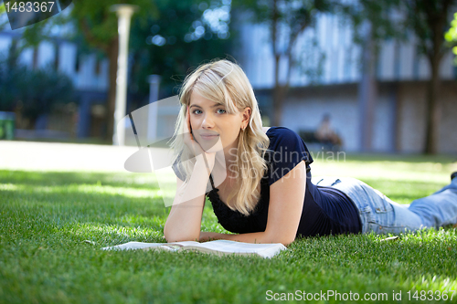 Image of Relaxed female student with book