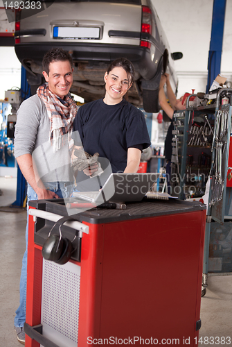 Image of Female Mechanic with Male Customer