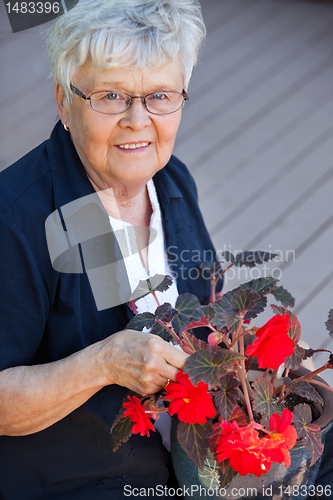 Image of Elderly woman with flower pot