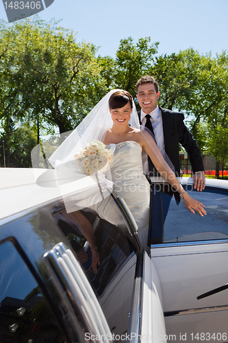 Image of Wedding Couple with Limousine