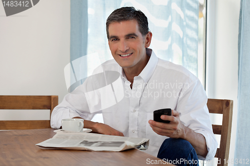 Image of Middle Aged Man Holding Cell Phone