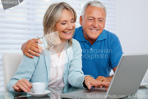 Image of Happy Couple Using Laptop