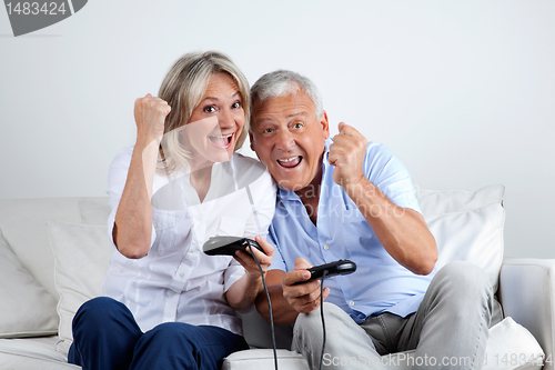 Image of Couple Having Fun Playing Video Game