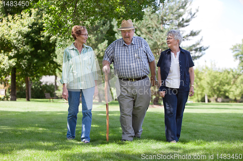 Image of Senior Friends Walking in Park