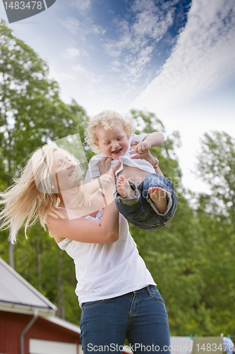 Image of Woman playing with little child