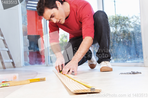 Image of Architect measuring the plank