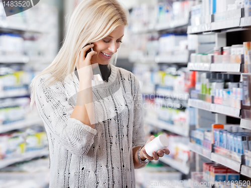 Image of Woman in Pharmacy Talking on Phone