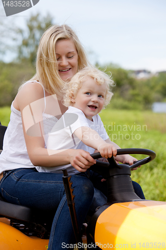 Image of Mother Driving Tractor with Son