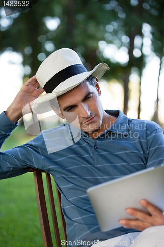 Image of Man Looking at Tablet PC Screen