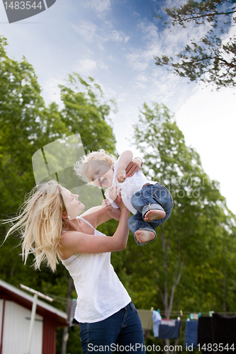 Image of Mother Throwing Son in Air