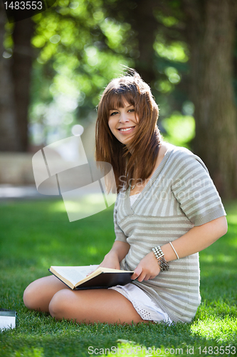 Image of College student holding book