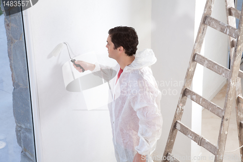 Image of Painter painting the wall