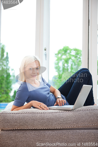 Image of Pretty female using laptop