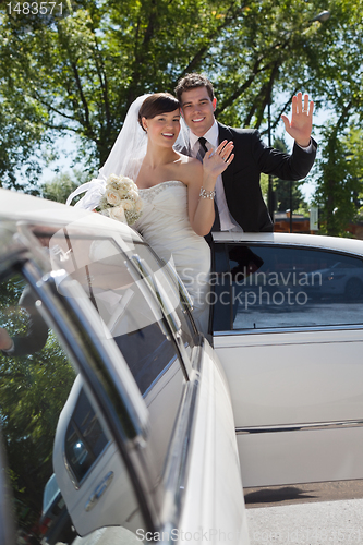 Image of Wedding Couple Waving