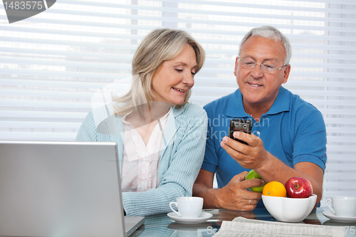 Image of Man Showing Phone to his Wife