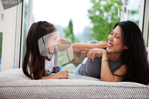 Image of Playful mother and daughter