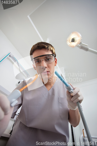 Image of Dentist using dental tools