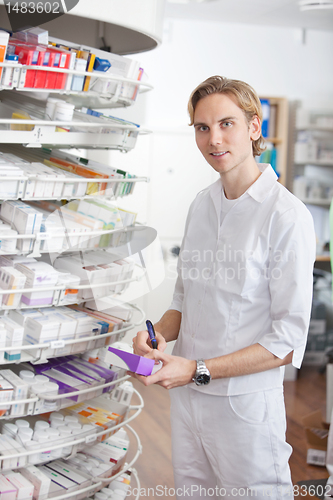 Image of Male Pharmacist Working at Drugstore