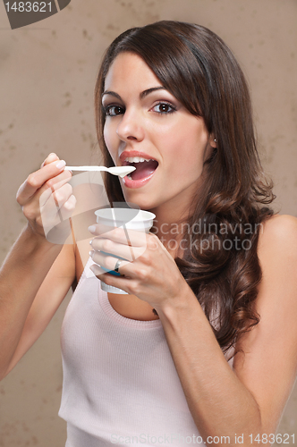 Image of Woman eating yogurt