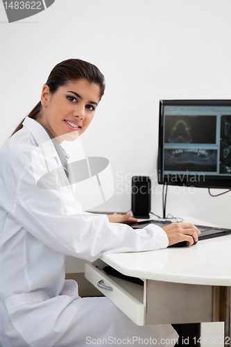 Image of Female dentist working on computer