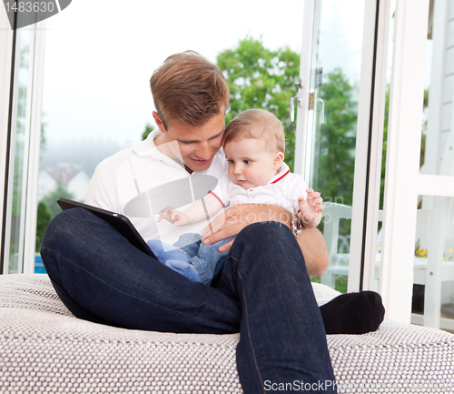 Image of Father Using Digital Tablet with Son