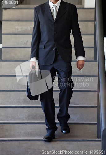 Image of Businessman Walking Down Stairs