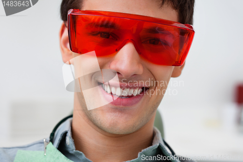 Image of Handsome dentist wearing protective eyewear