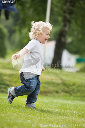 Image of Boy running in garden