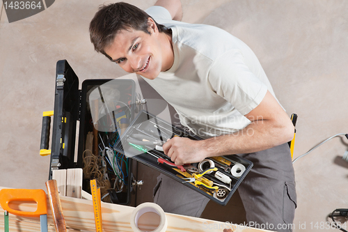 Image of Man holding tool box