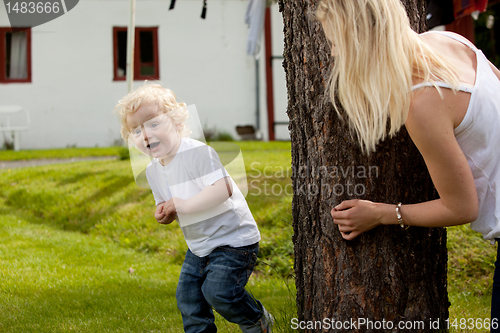 Image of Young Boy Playing Hide and Seek