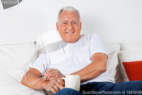 Image of Relaxed Senior Man Having with Warm Drink